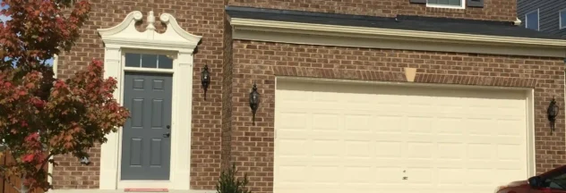 The Front of a Brick House With a White Shutter