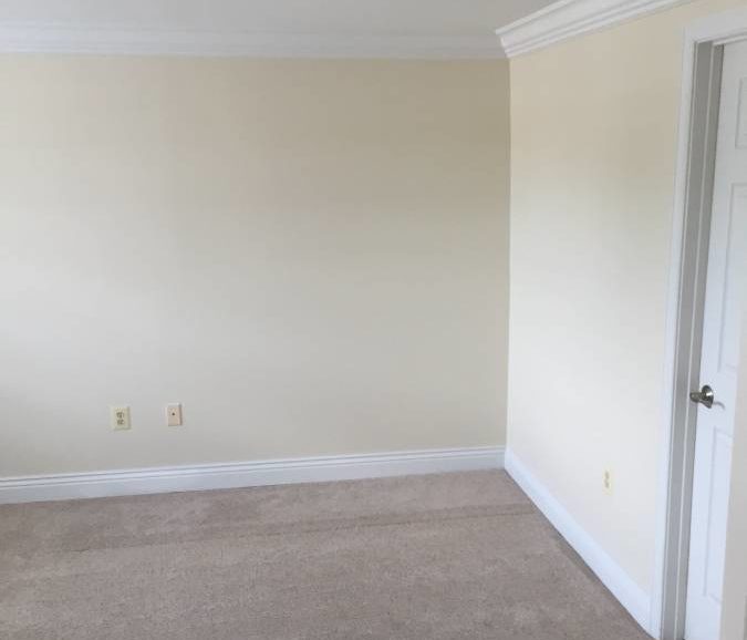Empty room with beige carpet and white walls.