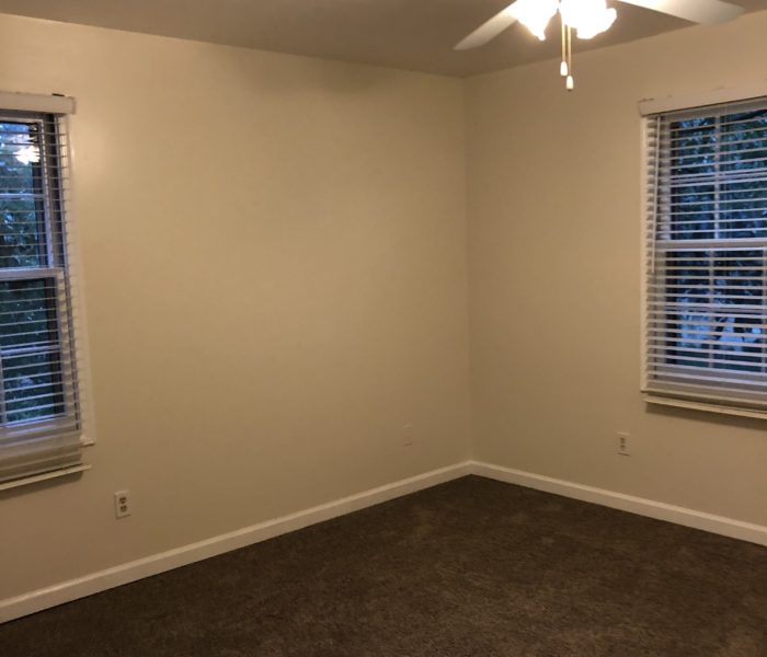 An Empty Room With a Ceiling Fan With Light