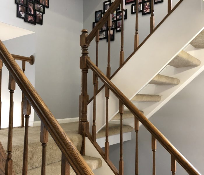 A staircase with pictures hanging on it.