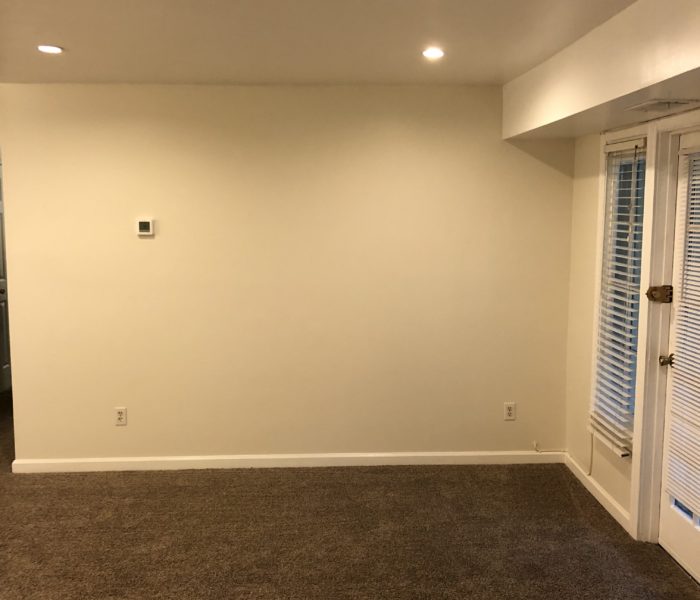 An Empty Room With a Carpet Flooring